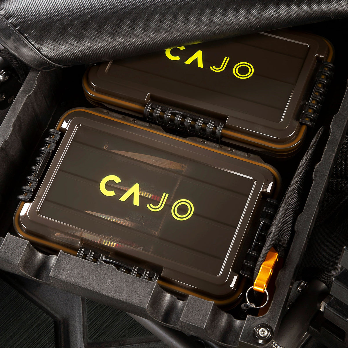 Waterproof tackle tray set, two amber trays with yellow Cajo logo in a kayak