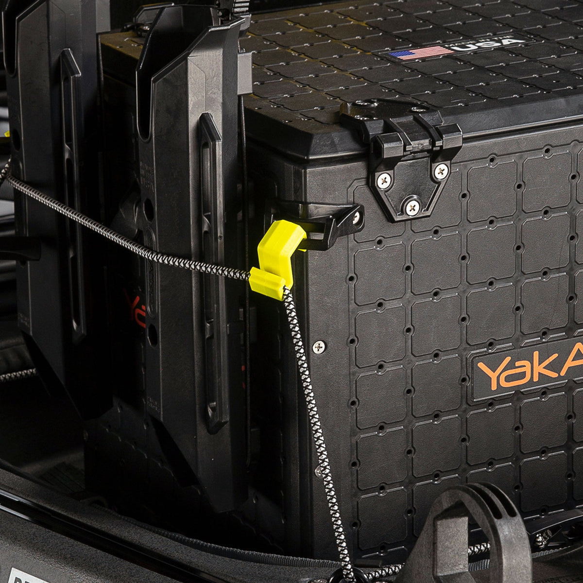 Delta Grip bungee gear hooks close-up with yellow hook and bungee cord on a crate