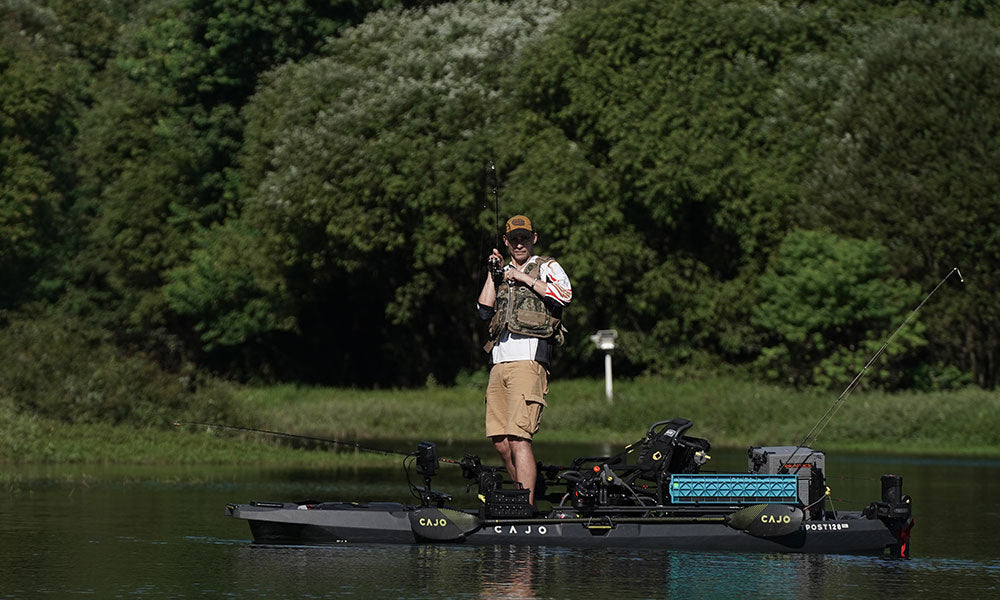 An angler standing to cast from a CAJO kayak