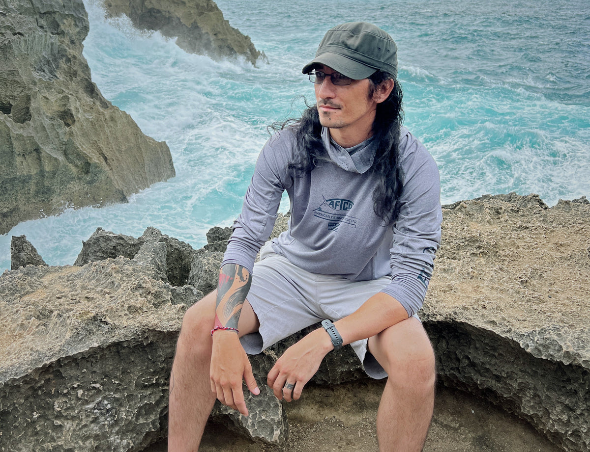 CAJO founder Josh Thomas on the rocks by the sea